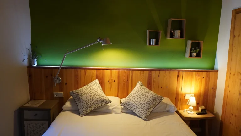 Habitació 4 amb llit doble i paret verda